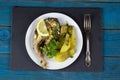 Fish steak with lemon and fried potatoes served on a white plate Royalty Free Stock Photo