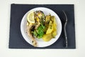 Fish steak with lemon and fried potatoes served on a white plate Royalty Free Stock Photo