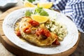 Fish steak with tomatoes and herb couscous