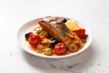 Fish steak stewed, olives and cherry tomatoes in tomato sauce