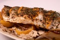 fish stuffed with lemon on a platter, diagonal side view