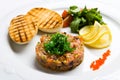 Fish tartare with vegetables and crackers