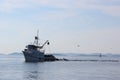 Fish trawler coming in a dusk