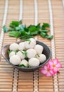 Fishballs in bowl on the bamboo floor.