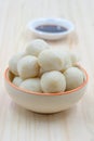 Fishballs in ceramic bowl on wooden background.