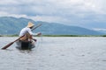 Fisheerman fishing ans sitting on small wooden boat on inle lake in myanmar Royalty Free Stock Photo