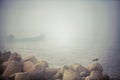 Fisher boat in the foggy sea in a calm early morning Royalty Free Stock Photo