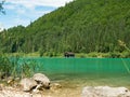 Fisher boat house and wooden hut with pier in the shore of Walchensee lake Royalty Free Stock Photo