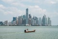 Fisher boat with modern skyscraper city skyline background - Pan Royalty Free Stock Photo