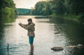 Fisher fishing equipment. Handsome man relaxing. Leisure on lake. Set up rod with hook line sinker. Bearded fisher in Royalty Free Stock Photo