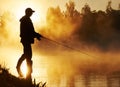 Fisher fishing on foggy sunrise Royalty Free Stock Photo