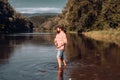 Fisher man fishing with spinning reel. Fly rod and reel with a brown trout from a stream. Fishing in river. Royalty Free Stock Photo