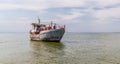 Fisheries on the Dnieper River. Old fishing trawler and sailors on the board