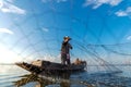 Fisherman action when fishing net on lake in the sunshine morning outdoors on the boat. Agriculture Industry,