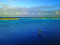 Aerial shot of an outrigger of the marshall islands in the pacific at sunset