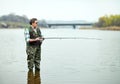 Fisherman angling on the river Royalty Free Stock Photo