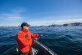 Fisherman athlete with a fishing rod in his hands. a boat. sea. Royalty Free Stock Photo