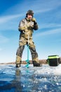 Fisherman with auger in winter ice fishing Royalty Free Stock Photo