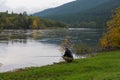 Fisherman on bank of Barguzin River on autumn day. Buryatia, Russia Royalty Free Stock Photo