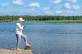 Fisherman on the bank fishes on spinning on the river Royalty Free Stock Photo