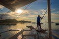 Fisherman on a banka, traditional filipino fishing boat at sunset, Cebu island The Philippines