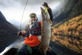 Fisherman and big trophy Pike. Royalty Free Stock Photo