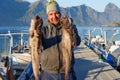 Fisherman with big wolffish near Lofoten, Senija, Alta Norway. Man holding catch Atlantic wolf fish Royalty Free Stock Photo