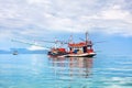 Fisherman boat on blue sea, sky, clouds landscape background close up, beautiful seascape with red wooden fishing vessel, Thailand Royalty Free Stock Photo