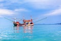 Fisherman boat on blue sea, sky, clouds landscape background close up, beautiful seascape with red wooden fishing vessel, Thailand Royalty Free Stock Photo