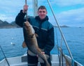 Fisherman on boat with codfish