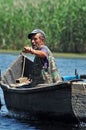 Fisherman in a boat in the Danube delta, Romania Royalty Free Stock Photo