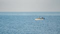 Fisherman in a boat fishing in the early morning. Mediterranean Sea Royalty Free Stock Photo