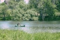 Fisherman in a boat fishing on the lake Royalty Free Stock Photo