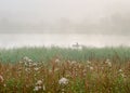 Fisherman on a boat in the fog Royalty Free Stock Photo