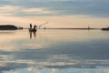 Fisherman in boat get fishing nets from river, Silhouette of fisherman,a dip net for fishing at Pakpra village, jijel Algeria Royalty Free Stock Photo