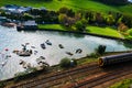 Fisherman boat harbour village with train passing on tracks Royalty Free Stock Photo