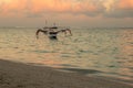 Fisherman boat jukung. Traditional fishing boat at the beach during sunset. Pandawa beach, Bali, Indonesia. Royalty Free Stock Photo