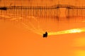 Fisherman on boat moving forward in river