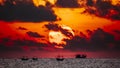 Fisherman on the boat over dramatic sunrise