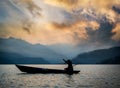 Fisherman on the boat on Phewa lake at sunset, Nepal