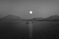 A fisherman in a boat with romantic night scenery