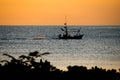 A fisherman boat silhouette at the sunrise time Royalty Free Stock Photo