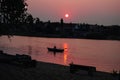 Fisherman in boat on the sunrise