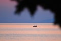 Fisherman in boat at sunset Royalty Free Stock Photo