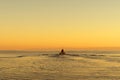 Fisherman on boat at the sunset. Beautiful sunset with the fishing boat. Fishing motor boat with angler. Ocean sea water wave