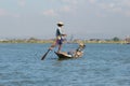 A fisherman in a boat unravels the fishing network. Myanmar