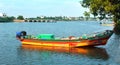 A fisherman boat waiting for the fisherman with ice box.