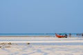 fisherman boats lay on the low water beach with clear sky