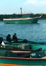 The fisherman boats waiting for the fishermen with ice box.