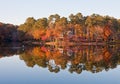 Fisherman on Calm Lake by Home in Autumn Royalty Free Stock Photo